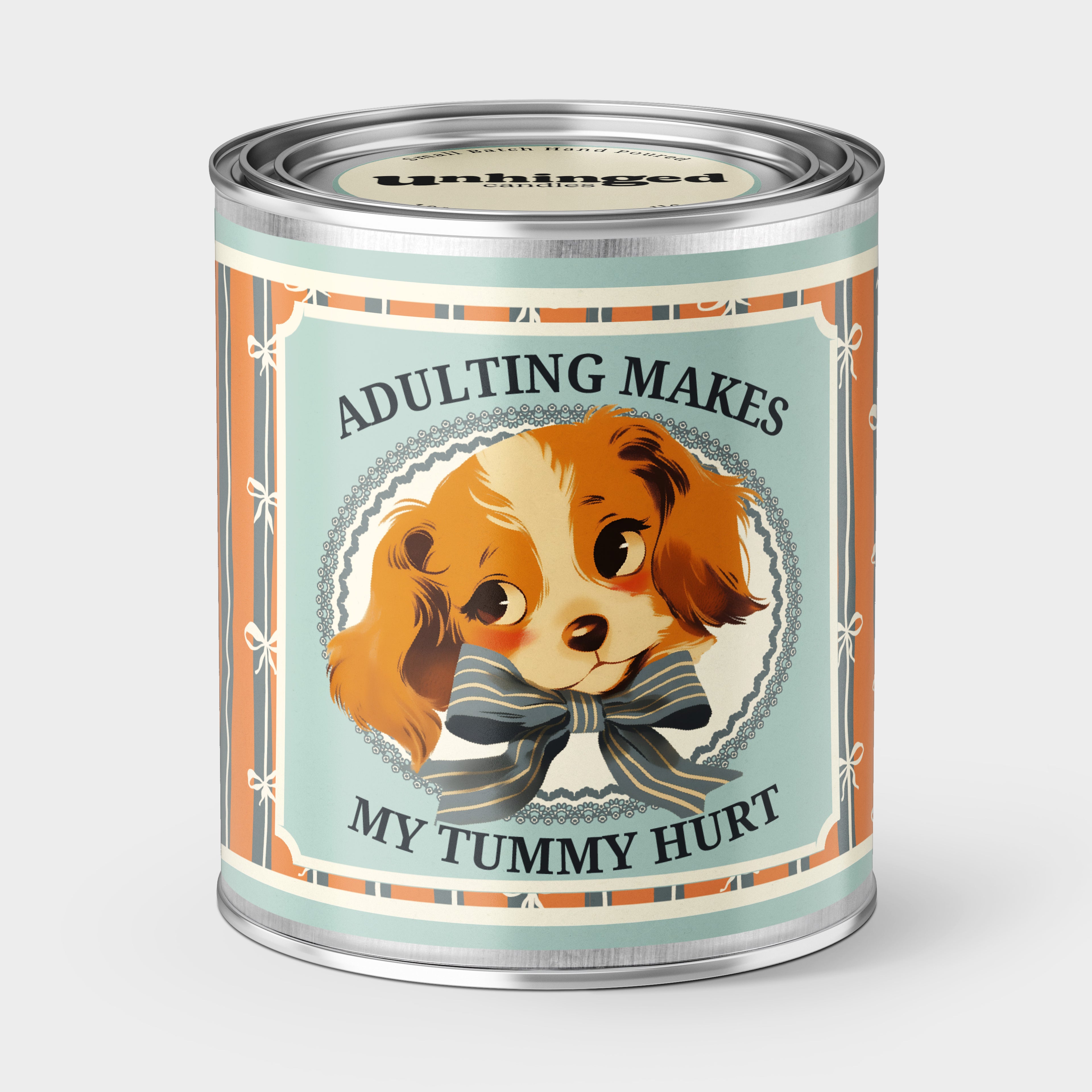 An Unhinged Paintcan candle with a picture of a vintage Puppy with the phrase "Adulting makes my tummy hurt".