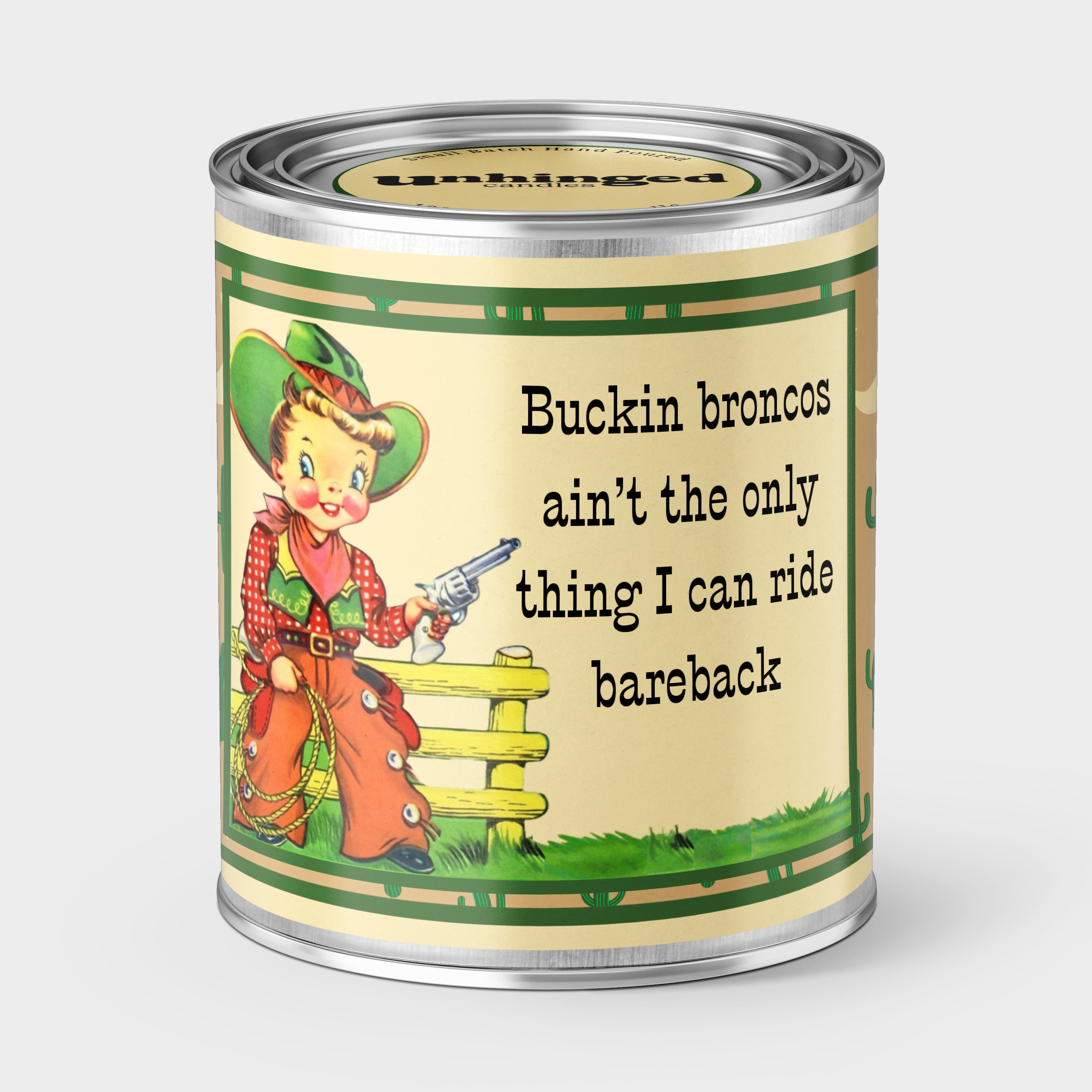 An Unhinged Paintcan candle with a picture of a vintage cowboy illustration holding a pistol witht he phrase "buckin broncos ain't the only thing I can ride bareback".