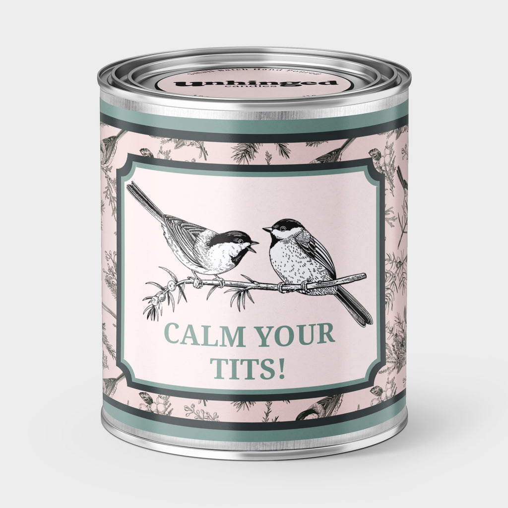 An Unhinged Paintcan candle with a picture of a two birds with the phrase "Calm your tits!"