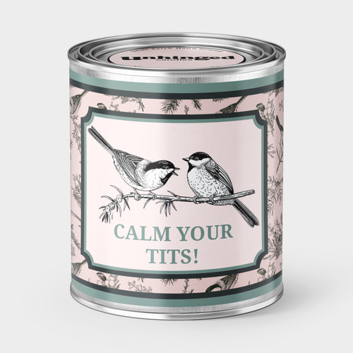 An Unhinged Paintcan candle with a picture of a two birds with the phrase "Calm your tits!"