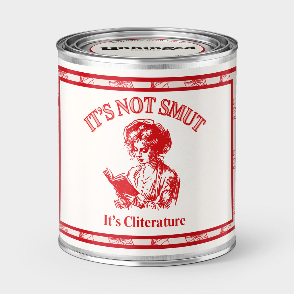 An Unhinged Paintcan candle with a picture of a a woman reading a book  with the phrase "It' not smut it's cliterature" on a red and white background.