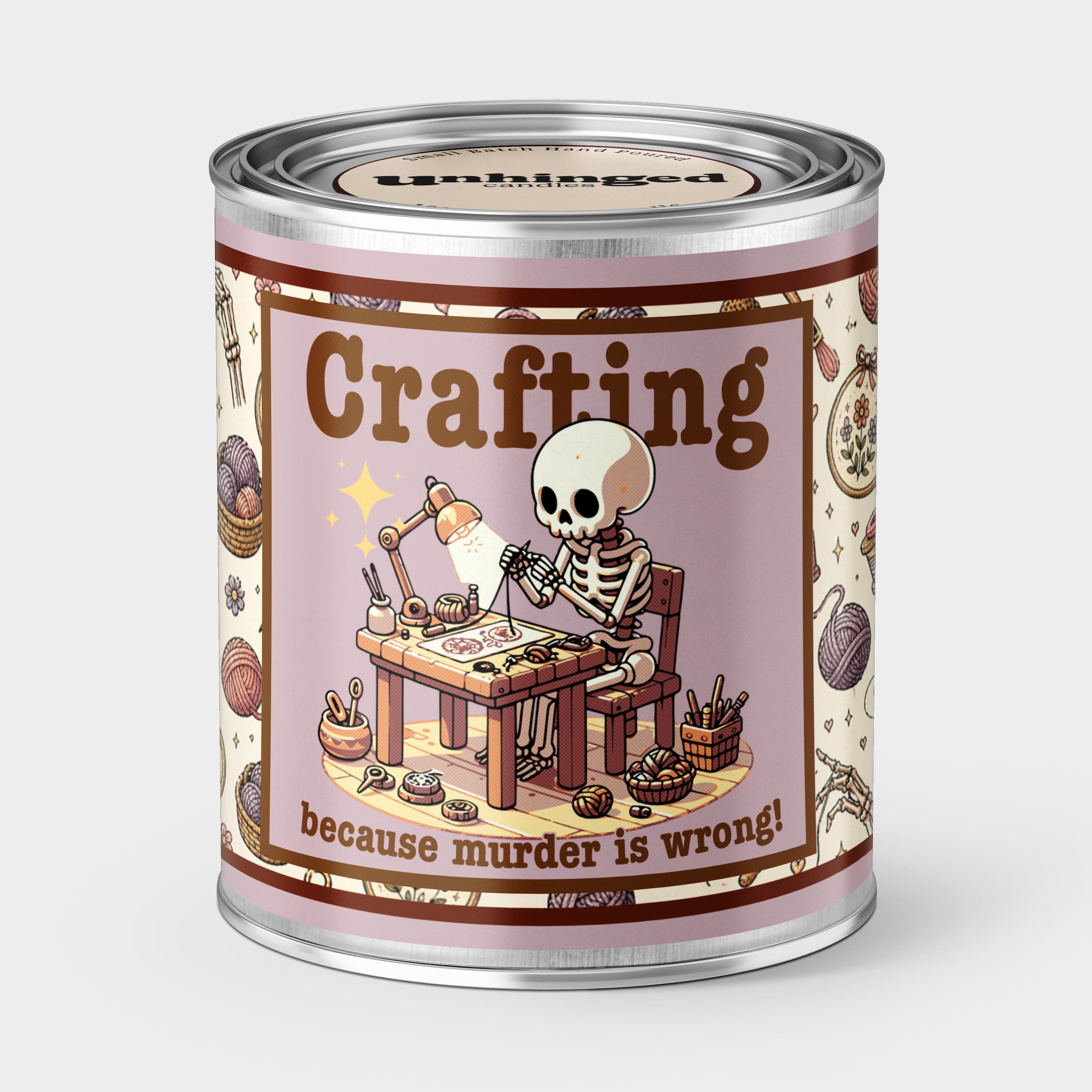 An Unhinged Paintcan candle with a picture of a a skeleton at a crafting table  with the phrase "Crafting because murder is wrong"