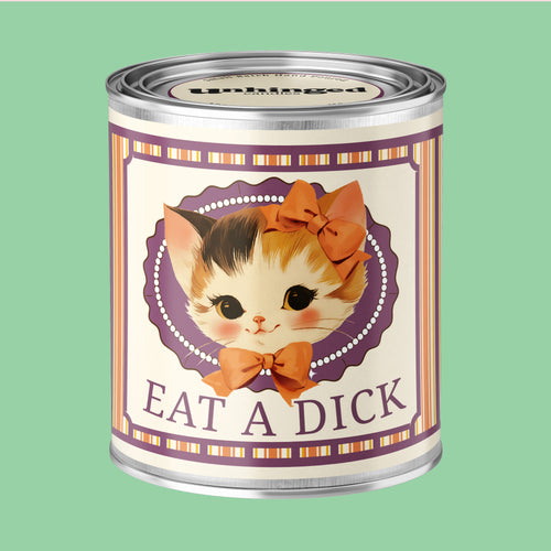 An Unhinged Paintcan candle with a picture of a cute kitten with a bow with the phrase "eat a dick" on a striped background