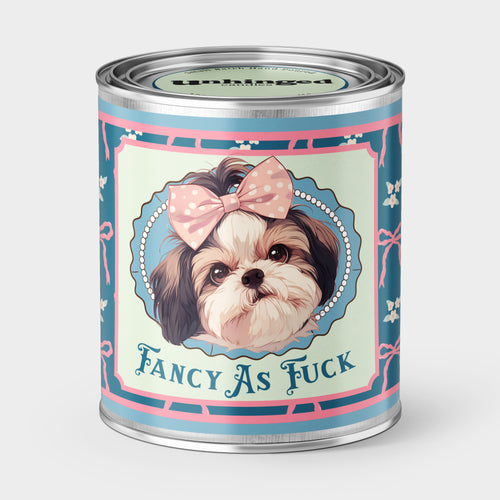 An Unhinged Paintcan candle with a picture of a cute puppy with a bow with the phrase "Fancy as fuck" on a blue and pink background. 