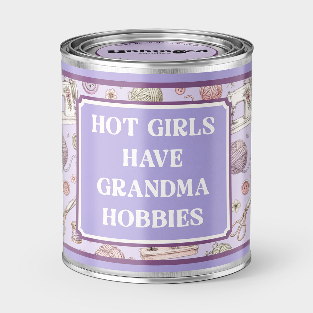 An Unhinged candle Paintcan vessel with the label "Hot girls have grandma hobbies" with a sewing and knitting background. 