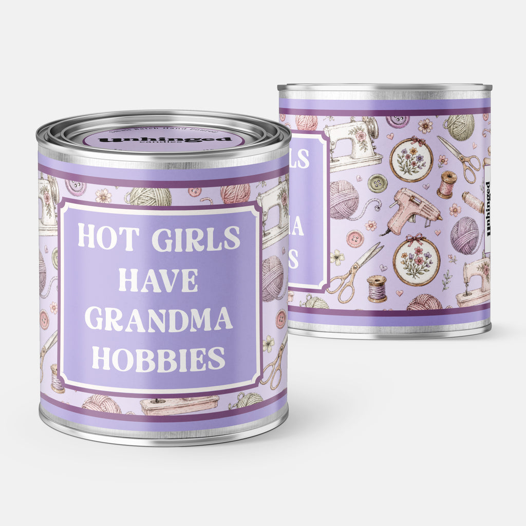 An Unhinged candle Paintcan vessel with the label "Hot girls have grandma hobbies" with a sewing and knitting background. 