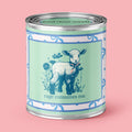 An Unhinged Paintball Candle with a peaceful lamb with the phrase "Rage Consumes Me" on a green and white background with blue ribbons. 