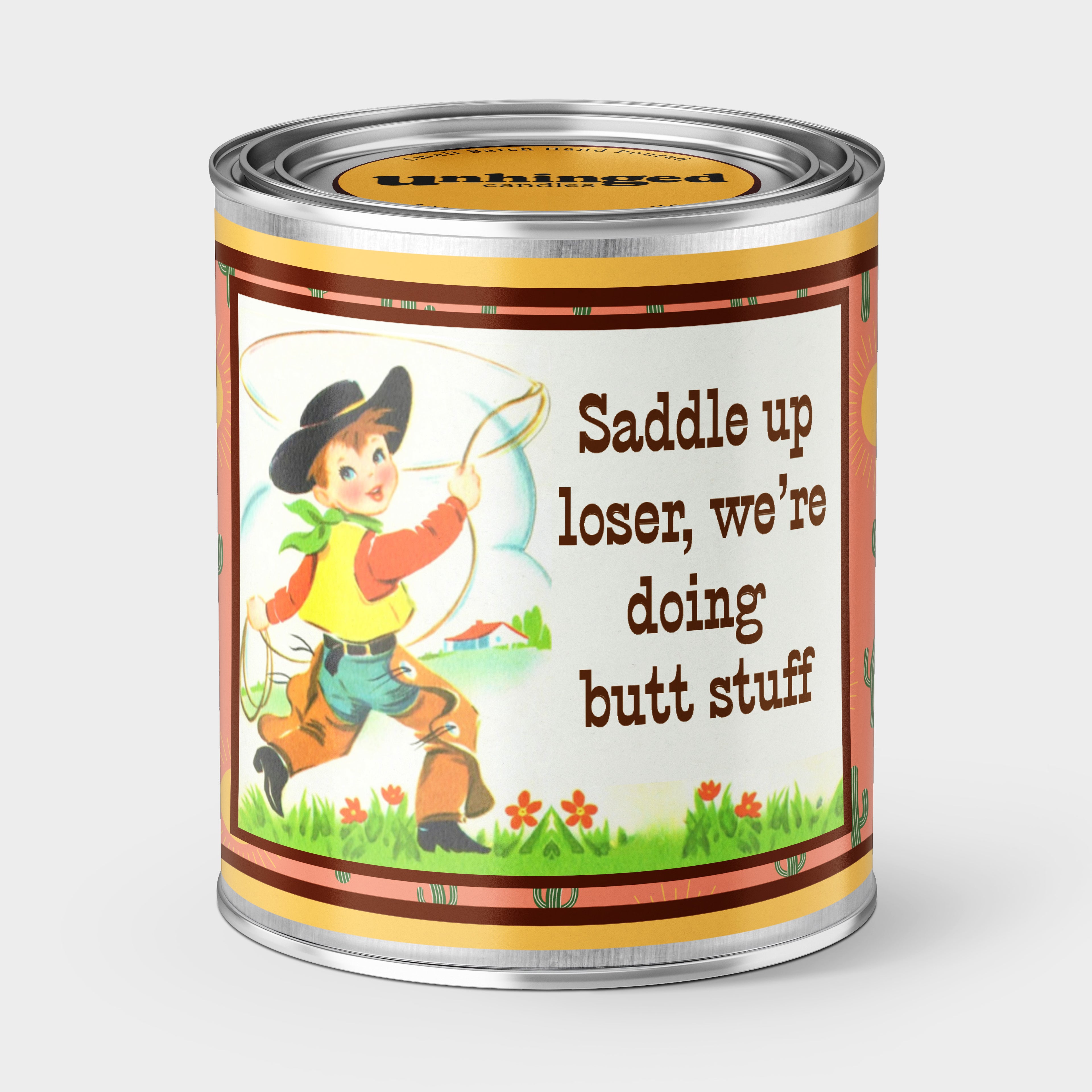 An Unhinged Candle Paint Can Candle with a vintage cowboy in chaps with the phrase, "saddle up loser, we're doing butt stuff" 