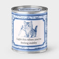 An Unhinged Candle Paintcan pint sized candle of a kitten holding a knife with the instructions "Light this when you're feeling stabby"