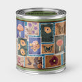 An Unhinged candle Paint can candle  with decorative design featuring postage stamps of flowers, mushrooms  and butterflies.