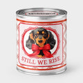 An Unhinged Candle Paintcan Candle with dachshund illustration and 'Still We Rise' text on a white background