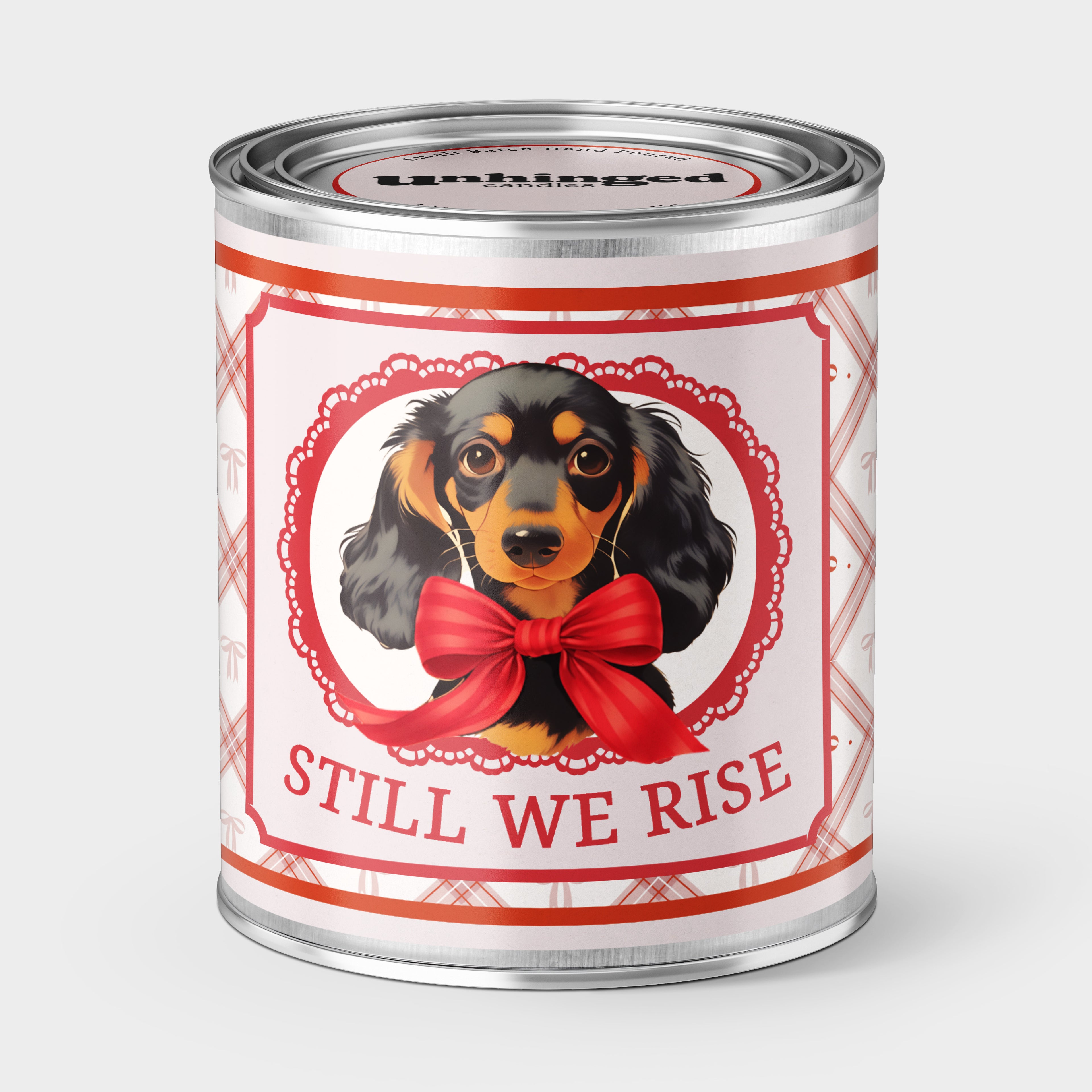 An Unhinged Candle Paintcan Candle with dachshund illustration and 'Still We Rise' text on a white background