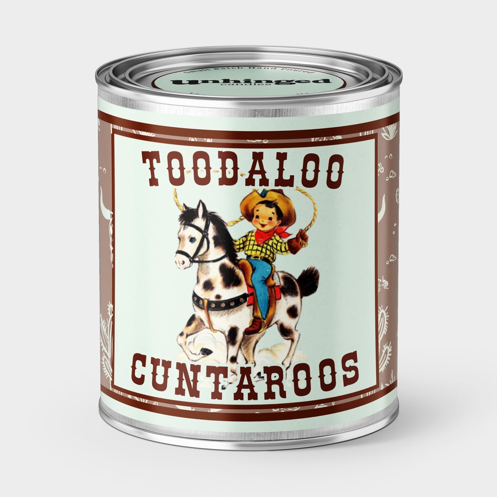 An Unhinged Pint Sized Paint can Candle with the phrase 'Toodaloo Cuntaroos' with a vintage drawing of a cowboy and horse illustration on a light blue background